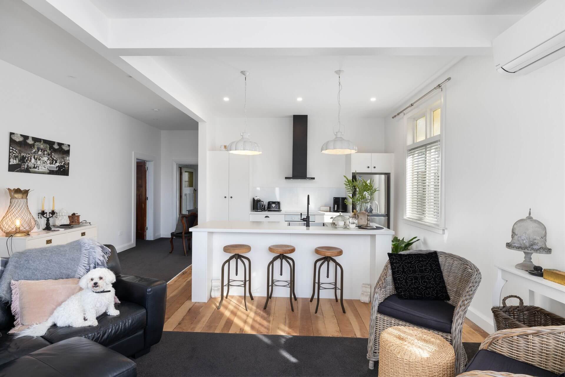 Character cottage kitchen lounge renovation with modern white cabinetry and island for seating