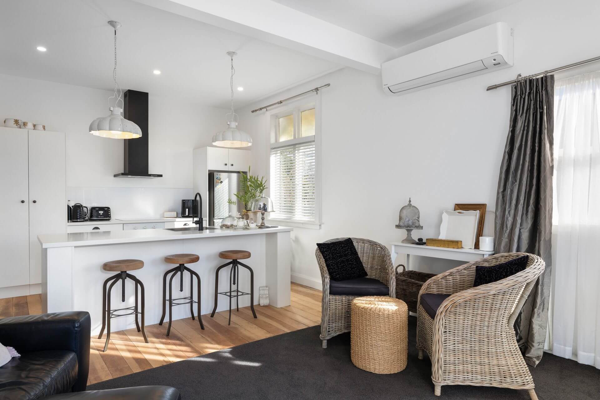 Character cottage kitchen lounge renovation with modern white cabinetry and island